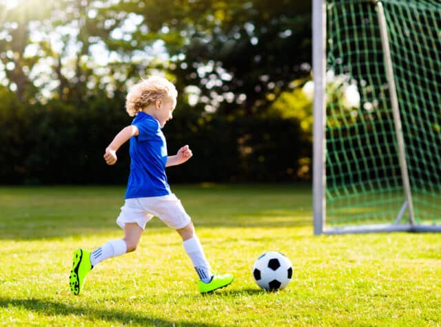 young boy playing soccer about to score a goal Fundamental Youth Sports Littleton Colorado